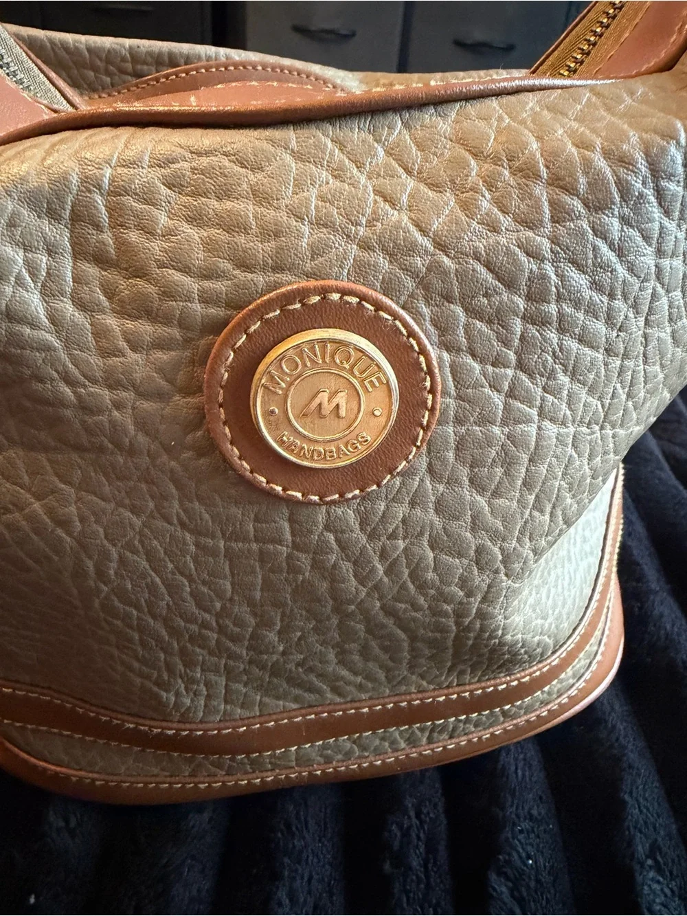 Monique Chantel beige leather handbag with tan trim and textured pebbled finish